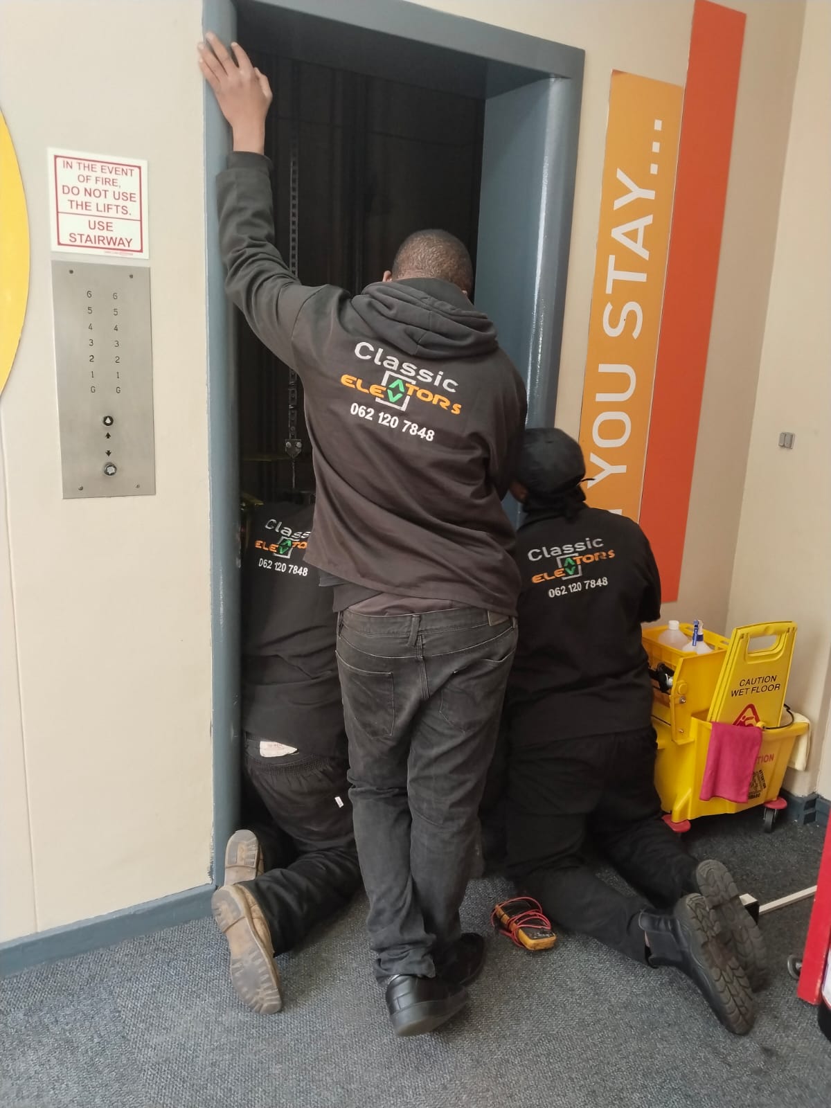 Technicians working at a lift entrance